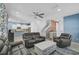 Spacious living room with grey leather furniture, a fireplace, and access to the backyard at 12196 Alachua Ln, Venice, FL 34293