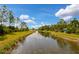 Serene canal with lush greenery and kayaks at 12196 Alachua Ln, Venice, FL 34293