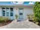 Front entry with light blue door and planters at 517 Circlewood Dr # Q13, Venice, FL 34293