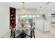 Elegant dining area with chandelier and view to kitchen at 517 Circlewood Dr # Q13, Venice, FL 34293