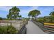 Scenic boardwalk path leading to a beach with wooden railings at 200 Gardens Edge Dr # 213, Venice, FL 34285