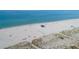 Beach with lifeguard stand and volleyball net, many people enjoying the beach at 200 Gardens Edge Dr # 213, Venice, FL 34285