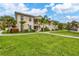 Condo building exterior with landscaping and walkway at 200 Gardens Edge Dr # 213, Venice, FL 34285