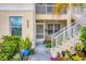 Building exterior with landscaped walkway, entrance, and stairs at 200 Gardens Edge Dr # 213, Venice, FL 34285