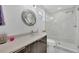 Modern bathroom with a walk-in shower and dark vanity at 200 Gardens Edge Dr # 213, Venice, FL 34285