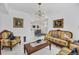Living room with ornate furniture and view into dining area at 200 Gardens Edge Dr # 213, Venice, FL 34285