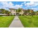 Condo building exterior with landscaping and walkway at 200 Gardens Edge Dr # 213, Venice, FL 34285