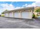 Four-car garage with individual garage doors at 200 Gardens Edge Dr # 213, Venice, FL 34285