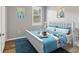 Bedroom with a full-size bed and blue accents at 19185 Mangieri St, Venice, FL 34293