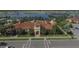 Community clubhouse with Spanish-style architecture and palm trees at 19185 Mangieri St, Venice, FL 34293