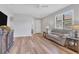 Living Room with light walls, wood floors, and a comfy couch at 19185 Mangieri St, Venice, FL 34293
