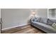 Cozy sitting area with gray sofa and wood flooring at 19185 Mangieri St, Venice, FL 34293