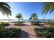Scenic walkway along the waterfront with palm trees and benches at 19185 Mangieri St, Venice, FL 34293
