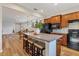 Open kitchen island with granite countertop and seating, looking toward living area at 19185 Mangieri St, Venice, FL 34293