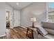 Living room with light walls, wood floors, and a comfy couch at 19185 Mangieri St, Venice, FL 34293