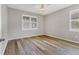 Spacious bedroom with wood flooring and plantation shutters at 19185 Mangieri St, Venice, FL 34293