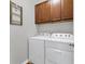Laundry room with washer, dryer, and upper cabinets at 19185 Mangieri St, Venice, FL 34293