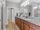 Double vanity bathroom with granite countertop and large mirror at 19185 Mangieri St, Venice, FL 34293