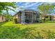 Private backyard oasis featuring a screened patio and lush landscaping at 19185 Mangieri St, Venice, FL 34293