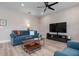 Spacious living room with comfortable blue sofa and wood coffee table at 376 Daylily Blvd, Nokomis, FL 34275