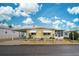 Yellow single-wide home with carport and landscaped yard at 628 Cervina Dr, Venice, FL 34285