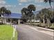 Attractive community entrance with palm trees and landscaping at 628 Cervina Dr, Venice, FL 34285