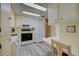 Bright kitchen features ample cabinetry, modern appliances, and wood-look flooring at 628 Cervina Dr, Venice, FL 34285
