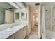 Bathroom boasts a marble-look shower, updated vanity, and wood-look flooring at 628 Cervina Dr, Venice, FL 34285