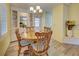 Bright dining area with round wooden table and chairs at 628 Cervina Dr, Venice, FL 34285