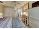 Main bedroom with wood-look flooring, ceiling fan, and built-in storage at 628 Cervina Dr, Venice, FL 34285