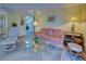 Living room with sofa, armchairs, and view into the kitchen at 628 Cervina Dr, Venice, FL 34285