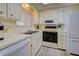 Well-equipped kitchen offers updated appliances and light wood-look flooring at 628 Cervina Dr, Venice, FL 34285