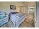 Bright bedroom with wood-look floors, ceiling fan and a view of the bathroom at 628 Cervina Dr, Venice, FL 34285