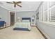 Charming bedroom with a queen bed and window shutters at 13091 Borrego St, Venice, FL 34293