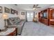 Comfortable living room featuring a plush gray sofa, ceiling fan, and large built-in entertainment center at 21019 Lawson Ave, Port Charlotte, FL 33952