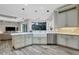 Well-appointed kitchen with marble countertops, stainless steel appliances, and a farmhouse sink at 2197 Nita Ter, North Port, FL 34286