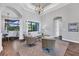 Bright living room featuring elegant chandelier, tray ceiling, with seamless flow to dining area at 2197 Nita Ter, North Port, FL 34286