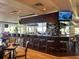 A restaurant and bar area with plenty of seating and a large bar at 262 Cerromar Way # 53, Venice, FL 34293