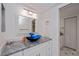 Modern bathroom with a blue vessel sink and granite countertop at 262 Cerromar Way # 53, Venice, FL 34293