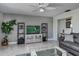 Living room features gray sofas, a large TV, and a marble floor at 262 Cerromar Way # 53, Venice, FL 34293