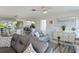 Living room with gray sofas, view into kitchen and dining areas at 262 Cerromar Way # 53, Venice, FL 34293