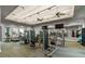 Community gym equipped with various machines, mirrors, and ceiling fans at 7801 Grande Shores Dr, Sarasota, FL 34240