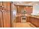 Well-equipped kitchen boasting stainless steel appliances and wood cabinets at 6360 Watercrest Way # 203, Lakewood Ranch, FL 34202