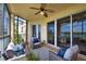 Relaxing screened balcony with wicker furniture and golf course view at 6360 Watercrest Way # 203, Lakewood Ranch, FL 34202