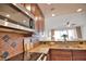 Kitchen with granite countertops, stainless steel appliances, and tile backsplash at 6360 Watercrest Way # 203, Lakewood Ranch, FL 34202