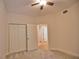 Bedroom with double doors leading to hallway and ceiling fan at 6360 Watercrest Way # 203, Lakewood Ranch, FL 34202