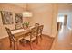 Well-lit dining area featuring a wooden table and stylish artwork at 6360 Watercrest Way # 203, Lakewood Ranch, FL 34202