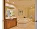 Spa-like bathroom featuring a soaking tub and walk-in shower at 6360 Watercrest Way # 203, Lakewood Ranch, FL 34202