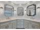 Double vanity bathroom with marble countertops and elegant mirrors at 2197 Nita Ter, North Port, FL 34286