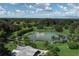 Aerial view of community with lake, lush landscaping, and clubhouse at 2197 Nita Ter, North Port, FL 34286